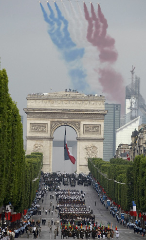 Alphajets from the French Acrobatic Patrol fly above the Arc de Triomphe during the annual Bastille Day military parade on the Champs-Elysée in Paris Wednesday.
